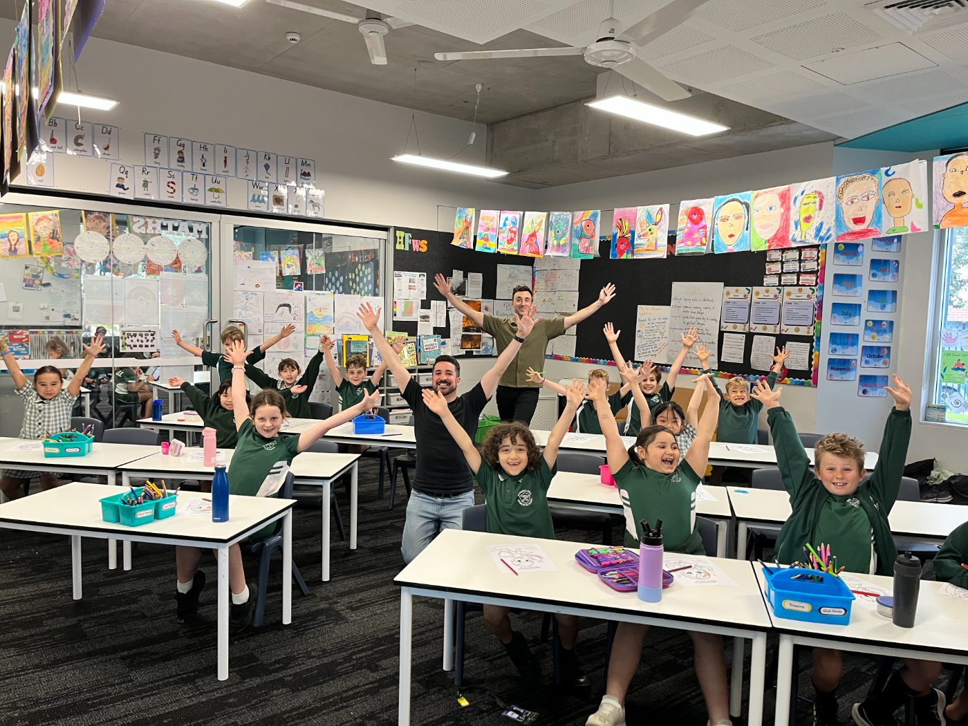 Students with their hands up in a Mighty Me class