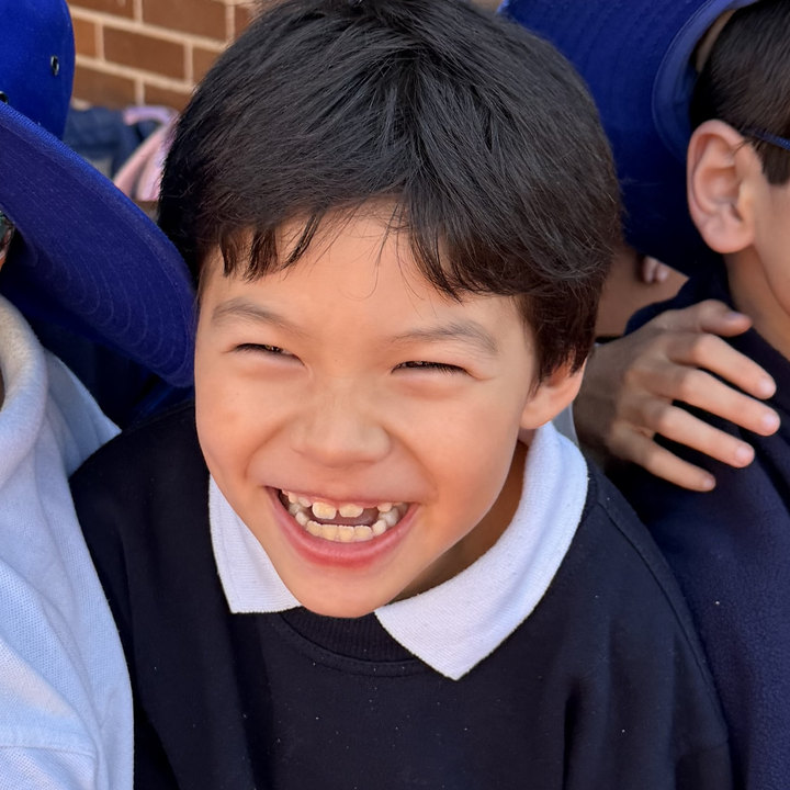 A student laughing with friends